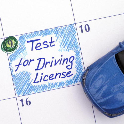 Reminder Test for Driving License in calendar with blue car toy